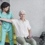 physiotherapist-working-with-elderly-patient-modern-clinic