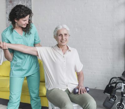 physiotherapist-working-with-elderly-patient-modern-clinic
