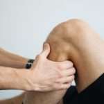 an athlete getting Knee pain relief massage