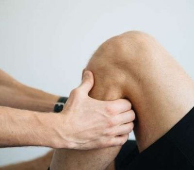 an athlete getting Knee pain relief massage