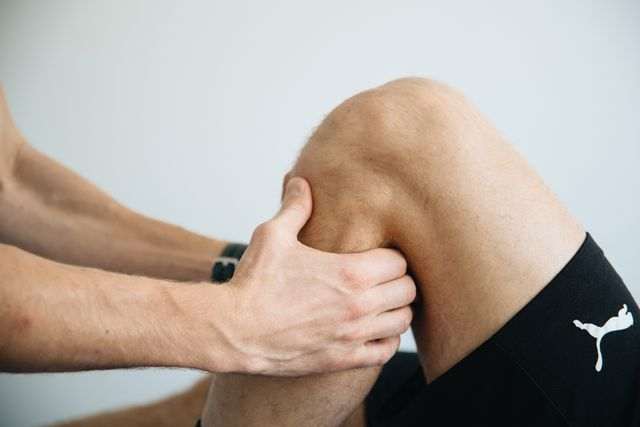 an athlete getting Knee pain relief massage