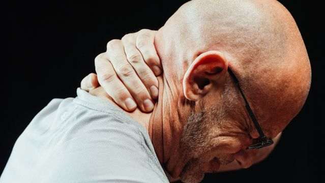 Senior man experiencing neck soreness and muscle stiffness